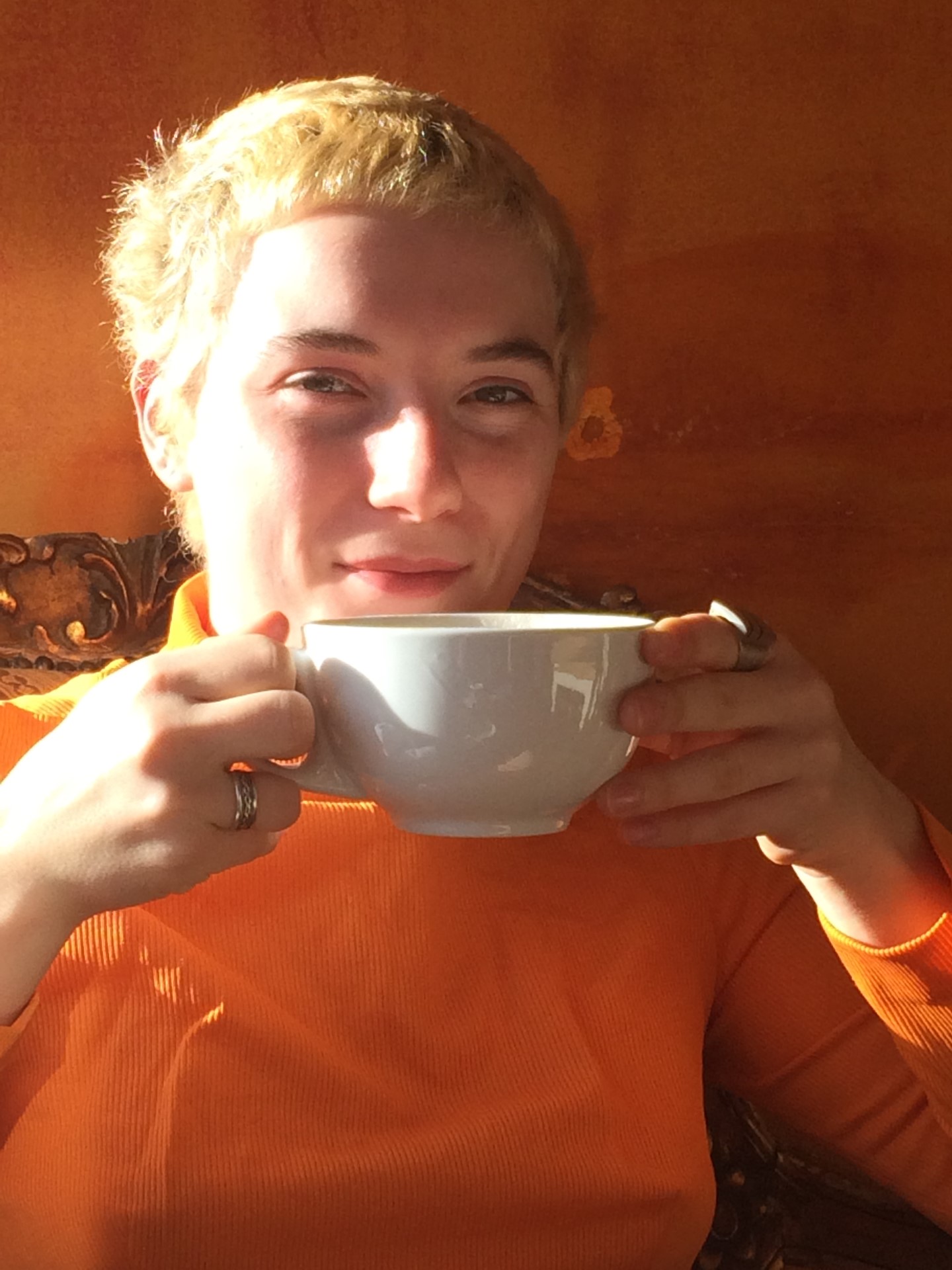 Evie In Orange & Drinking Coffee